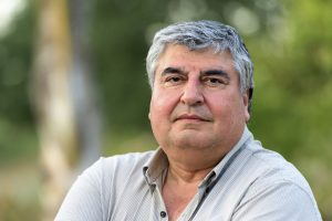 Smiling mature hispanic man posing looking at the camera